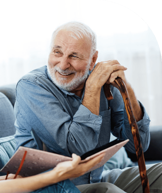 Elderly man smiling while receiving non-emergency medical transportation assistance in Brooklyn.