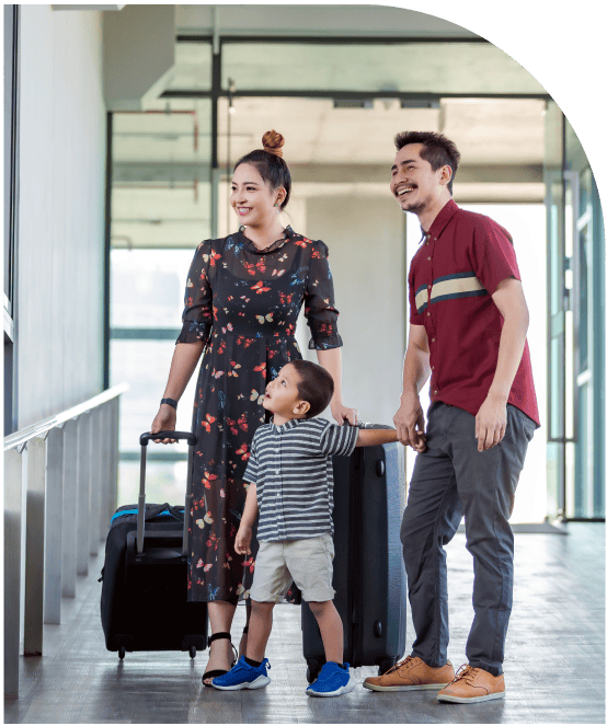 Family with luggage at airport using flat-rate transfer service from Brooklyn to JFK, LGA, or EWR.